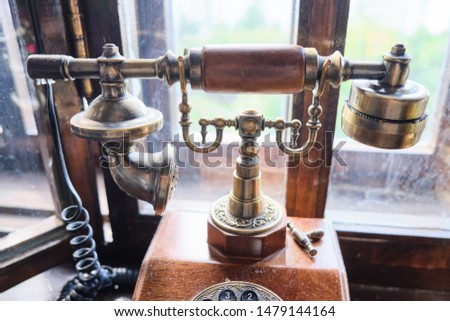 Vintage old wooden vintage telephone close up.