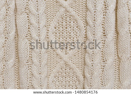 Close up of white knitted sweater background, texture 


