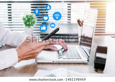 Businessman using smart phone on office desk, Social media concept