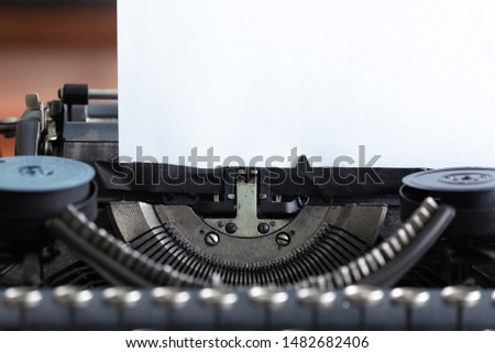 Old typewriter and a blank paper page with a copy space.