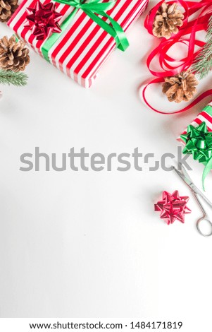 Preparation for Christmas background with gifts box, xmas decoration, coffee cappuccino cup and clear notepad for wishes, gift list or to do list. Top view flatlay copy space