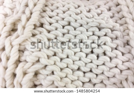 Close up of white knitted sweater background, texture 


