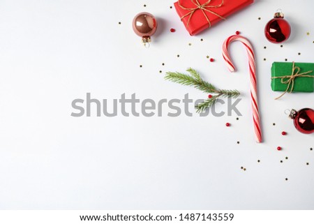 Flat lay composition with Christmas gifts and festive decor on white background. Space for text