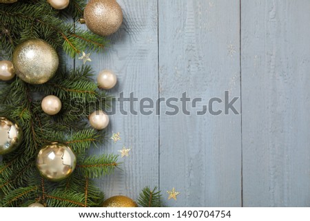 Fir branches with Christmas decoration on grey wooden background, flat lay. Space for text