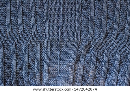 Blue knitted fabric close up, background or texture