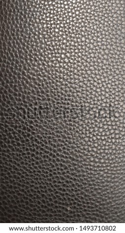 Genuine black skin shot close-up. Glare, background, texture.