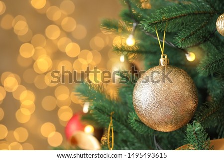 Beautiful Christmas tree with decor against blurred lights on background