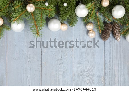 Fir branches with Christmas decoration on grey wooden background, flat lay. Space for text