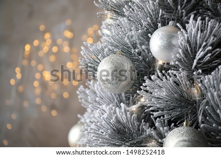 Beautiful Christmas tree with decor against blurred lights on background. Space for text
