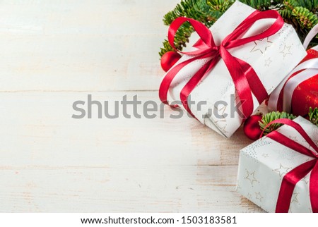 Christmas festive background with christmas tree branches and xmas gift boxes, top view copy space