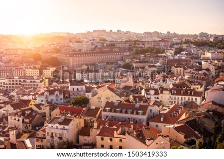Aerial view of Lisbon in Portugal at sunset as seen from Miradouro da Graca at Alfama Neighborhood. 
