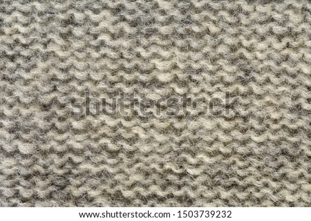 Knitted gray background. The texture of the knitted fabric.