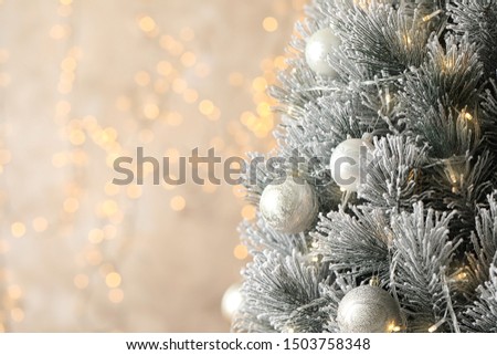Beautiful Christmas tree with decor against blurred lights on background. Space for text