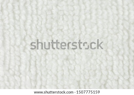 Closeup white natural cotton textile background.
Abstract seamless bath towel texture.
top view.