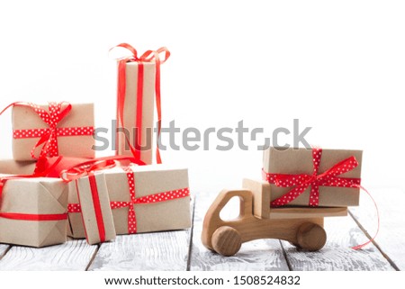 Toy car with Christmas gifts and tree isolated on white backround. Delivery.