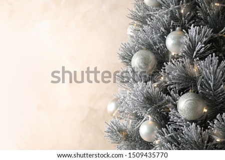 Beautiful Christmas tree with decor on light background. Space for text