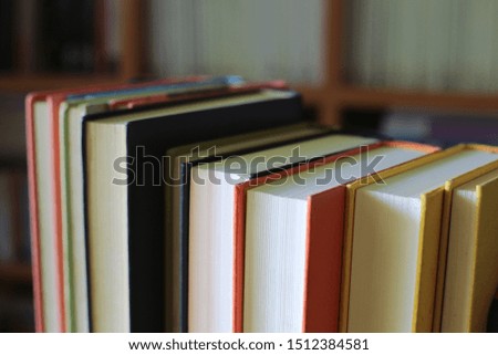 Close-up of several books arranged in rows in the library. Bookshelf is the background selective focus and shallow depth of field