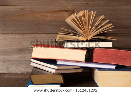 Many old books on wooden background.