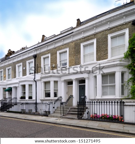 London street of terraced houses without parked cars. 