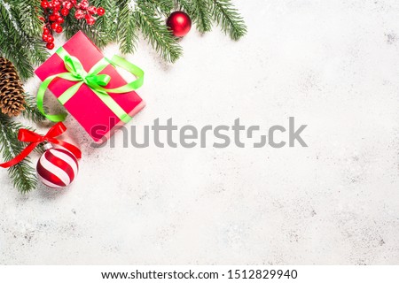 Christmas flat lay background on white. Fir tree, cones, present box and decorations. Top view with copy space.
