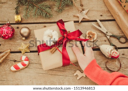 Female hands holding christmas gift box/composition concept background