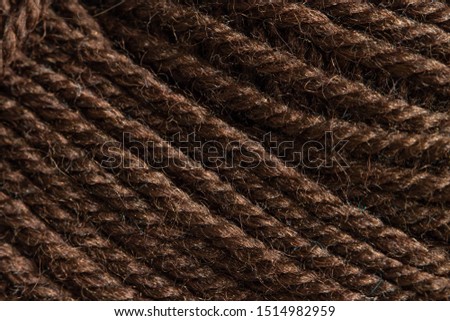 Chocolate knitting brown yarn closeup texture background
