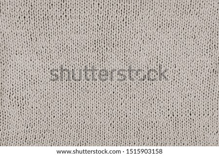 Knitted T shirt yarn knit background. Grey Knitted Fabric Texture. Knitwear needlework hobby background.