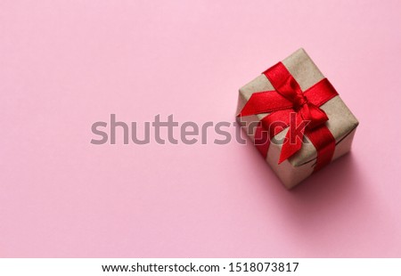 Single gift box on pink solid background. Sale concept. Gifts shop. Sale coupon. Space for your text.