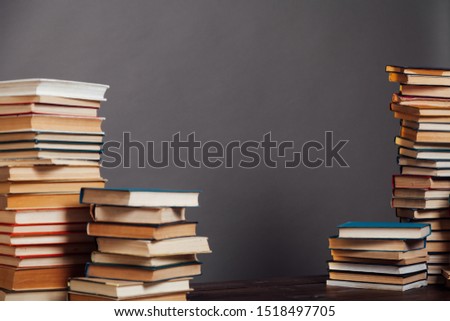 a lot of different educational books on a gray background