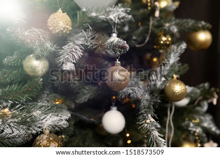 Close-up of a beautifully decorated Christmas tree with garlands and toys before the holiday
