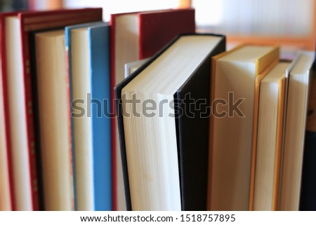 Close-up of books arranged on a bookshelf in the library selective focus and shallow depth of field