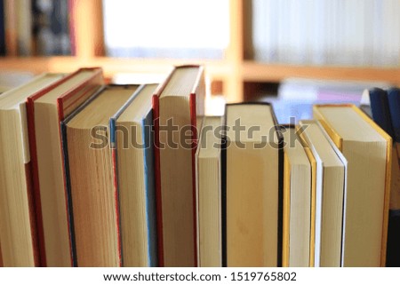 Close-up of books arranged on a bookshelf in the library selective focus and shallow depth of field