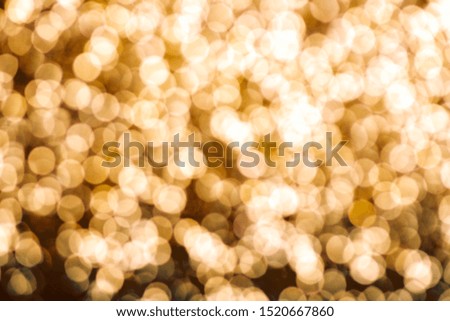 Abstract background, defocused image with bokeh effect of gold color, festive xmas spirit