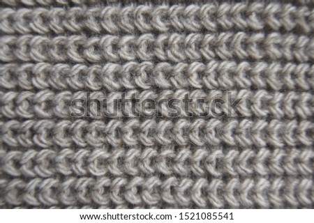 Simple pearl rib pattern textile wallpaper with empty space. Handmade knit warm cloth close up. Stitch knitted garment made of delicate wool yarn. Elegant textured material with woolly surface