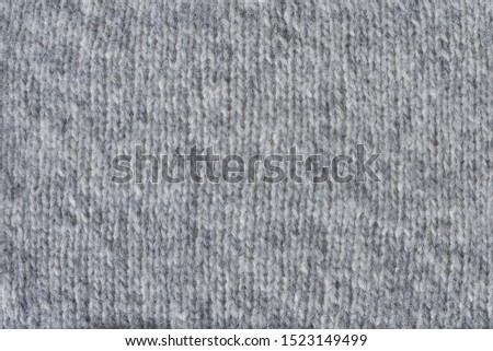 Knitted gray background. The texture of the knitted fabricю.