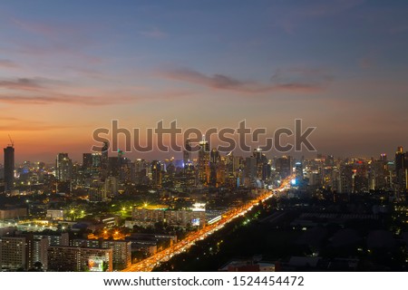 Panorama of landscape with sunset over the building and blue sky at bangkok ,Thailand. View of the tall building in capital with twilight 