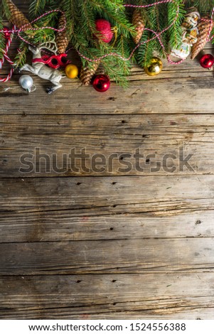 Christmas greeting background with Christmas tree branches, traditional decorations, gifts and xmas balls. Classic wooden background, top view flat lay copy space