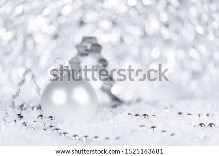 Fir tree cutter, bauble and pearls in color white and silver, snowflakes in the front