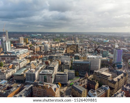 Aerial photo taken on the centre of Leeds in the UK, showing the typical British town centre along with hotels, businesses and shopping centres, taken on a bright sunny part cloudy day
