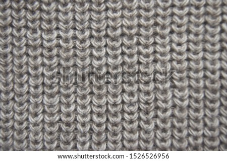 beige pearl rib pattern textile wallpaper with empty space. Handmade knit warm cloth close up. Stitch knitted garment made of delicate wool yarn. Elegant textured material with woolly surface