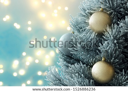 Decorated Christmas tree against blurred lights on background, space for text. Bokeh effect