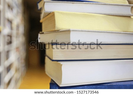 Stack of books on table in library