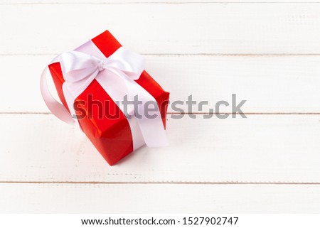 White wooden table with wrapped gifts top view