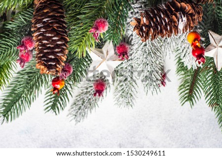Christmas frame concept with fir tree, cones and holiday decor on stone background with copy space