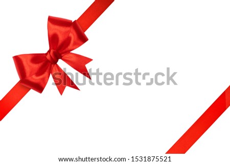 Ribbon and bow of shiny red satin on white background. Christmas card