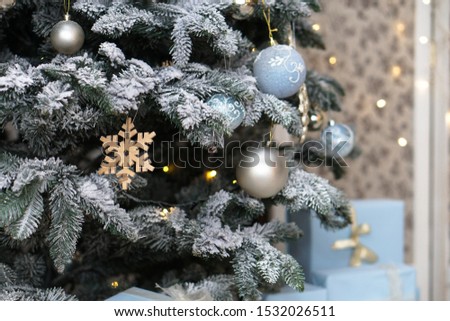 Christmas tree decorated with toys and a garland. New year background for your design. Seasonal holidays in winter