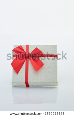 White gift box with red ribbon bow on white background, big sale, The minimal concept of giving different festive gifts, copy space for text