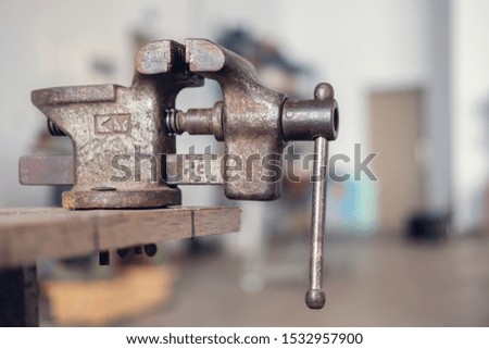 Old rusty vise with blurred background, selective focus