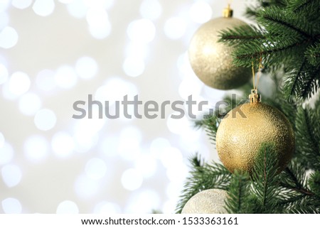 Beautiful decorated Christmas tree against blurred lights, closeup with space for text. Bokeh effect