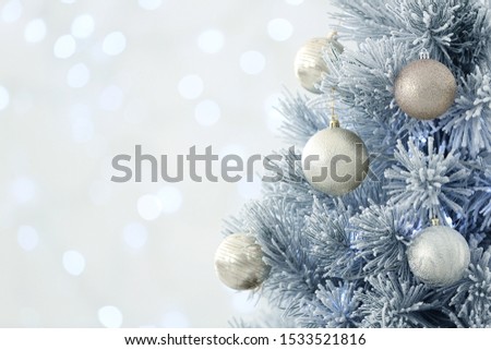 Beautiful decorated Christmas tree against blurred lights, closeup with space for text. Bokeh effect